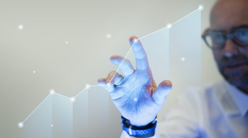 Businessman pointing his finger to a growth graph Businessman pointing his finger to a growth graph