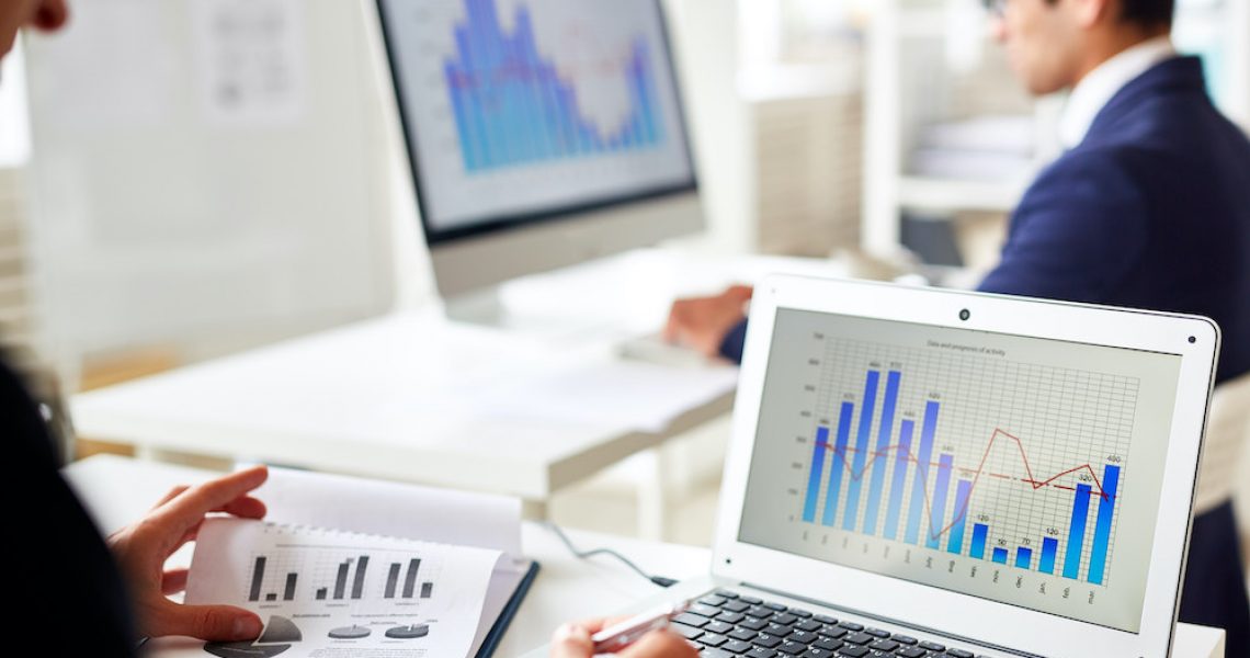 Online statistics Statistics chart on laptop display and trader analyzing the data